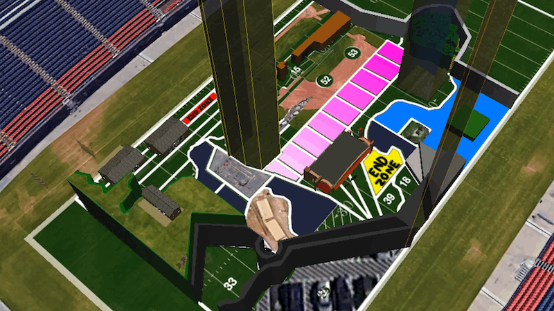Shown is a 3D render of the inside of a football stadium shown from above, though you would not recognize it. Covering the grass is a random colorful blueprint with no clear shape. Two-digit numbers and the words 'End Zone' are placed in odd places between large 3D shapes, some rising above the image.